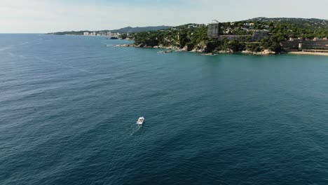 A-boat-sailing-through-mediterranean-shore