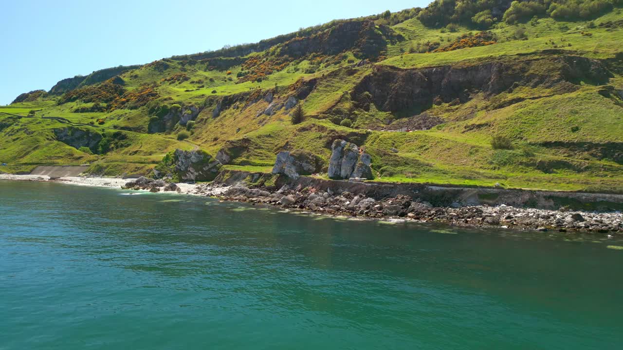 Reversing aerial video of Madman's Window on the Causeway Coastal Route in County Antrim, Northern Ireland, UK, on a bright and sunny day. Filmed in 4K, 60FPS and with Rec709 color.
