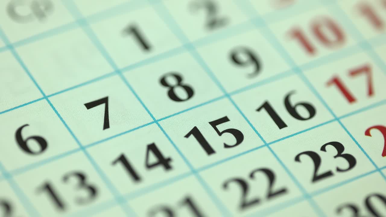 7th – seventh day of the month. The woman marks the calendar date with a blue marker