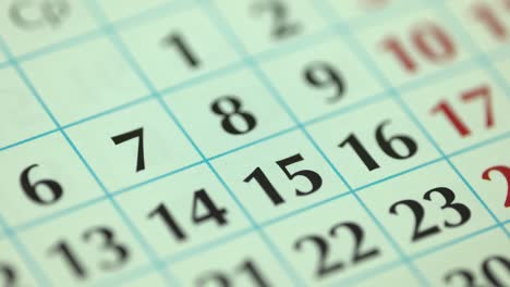 7th – seventh day of the month. the woman marks the calendar date with a blue marker