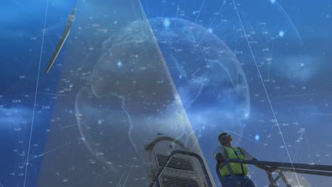 animación de rastros de luz sobre el globo contra ingeniero masculino usando portátil de pie en el molino de viento