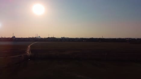 drone aerial footage over a park with view onto the setting sun graded footage from germany