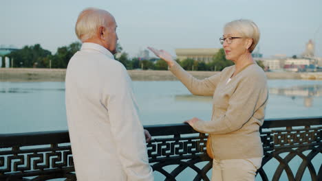 senior couple enjoying time by the river