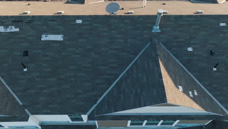 Aerial-top-down,-gray-roof-shingle-tiles-on-a-suburban-townhouse-home