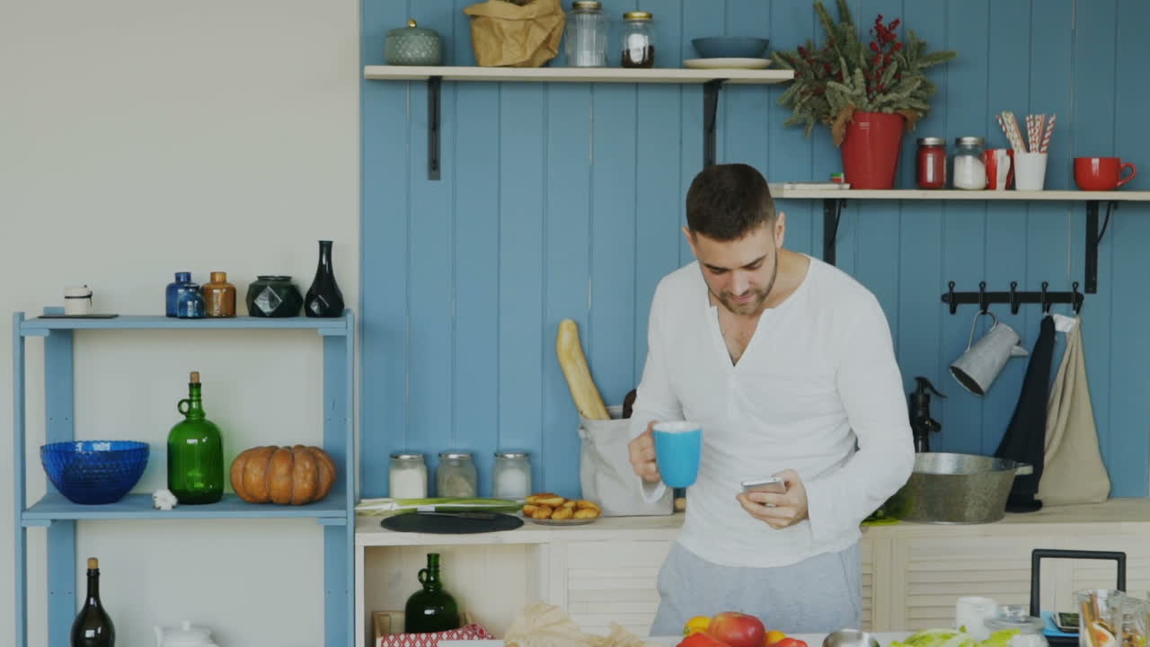 Man using mobile phone in kitchen