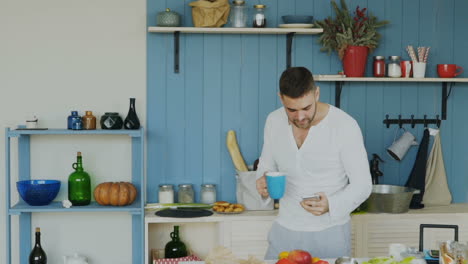 man using mobile phone in kitchen