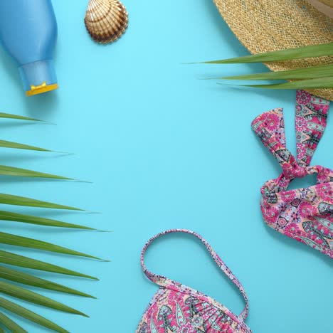 women beach summer clothes and accessories collage on blue background