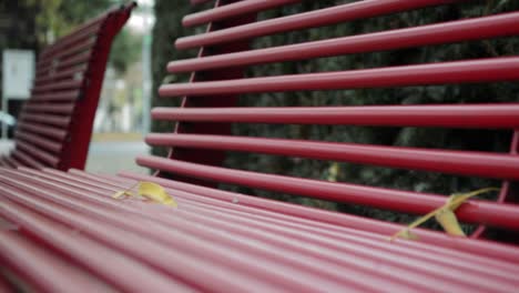 stunning red metal made bench in the small town on the cold autumn morning