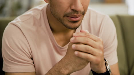 man sitting, hands clasped