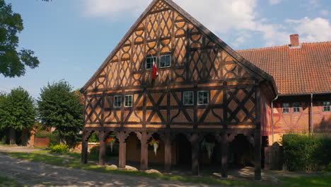 aerial shot of charming mennonite arcade house in poland's historic town, a glimpse of timeless architecture drone flying left