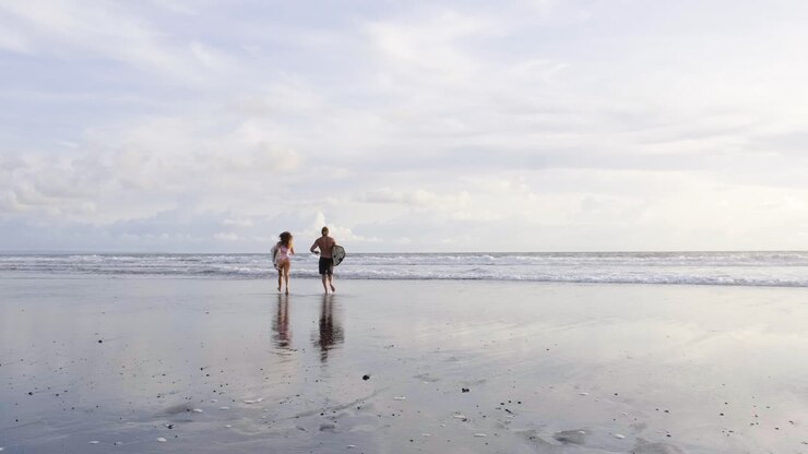 Young couple with surfboards