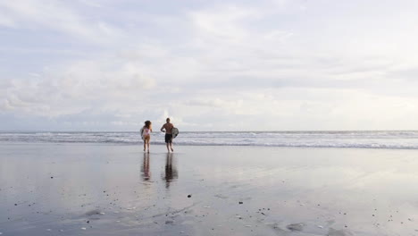 young couple with surfboards