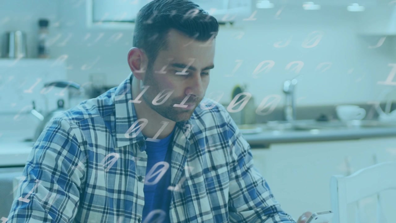 Man eating while checking smartphone at kitchen table, tech binary overlaying bowl and man