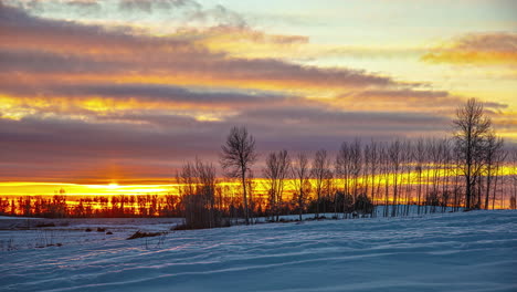 time lapse sunrise on snowy countryside