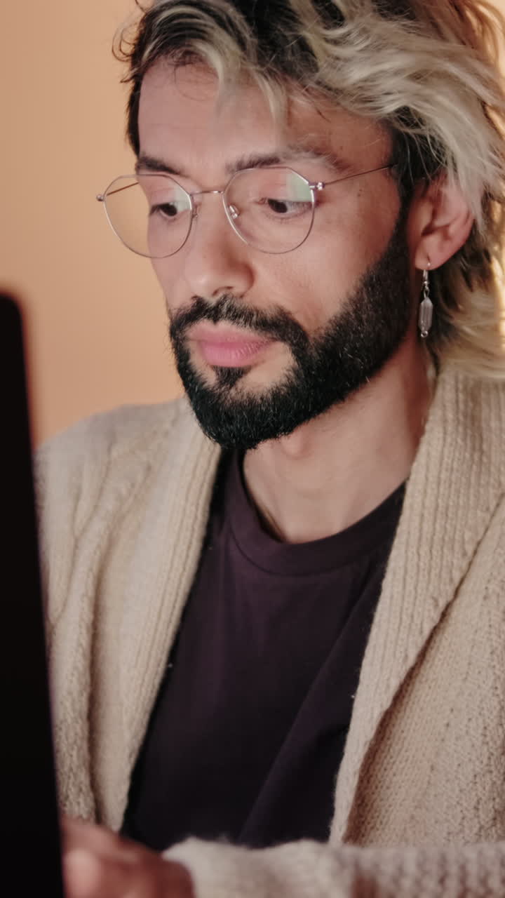 Gay Couple at Home Working on Laptop