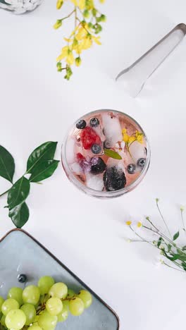 refreshing rosé cocktail with berries and flowers