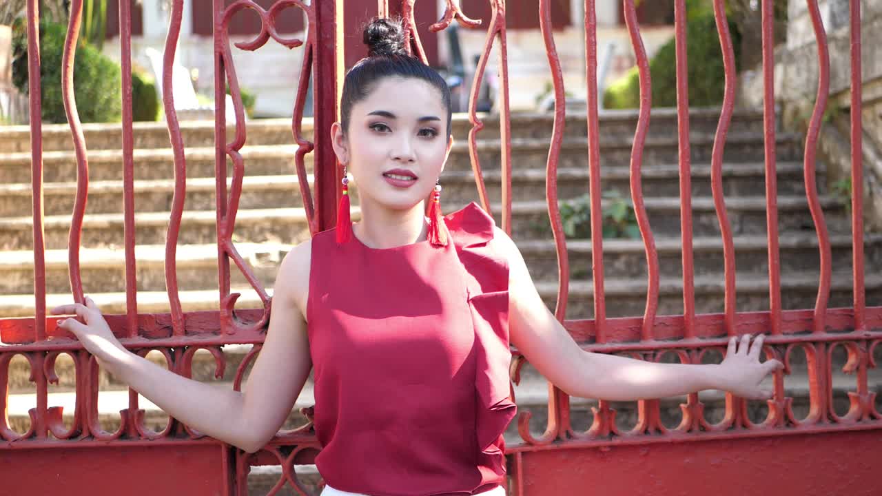 Beautiful Asian Woman Pose At Red Metal Fence , Slow Motion