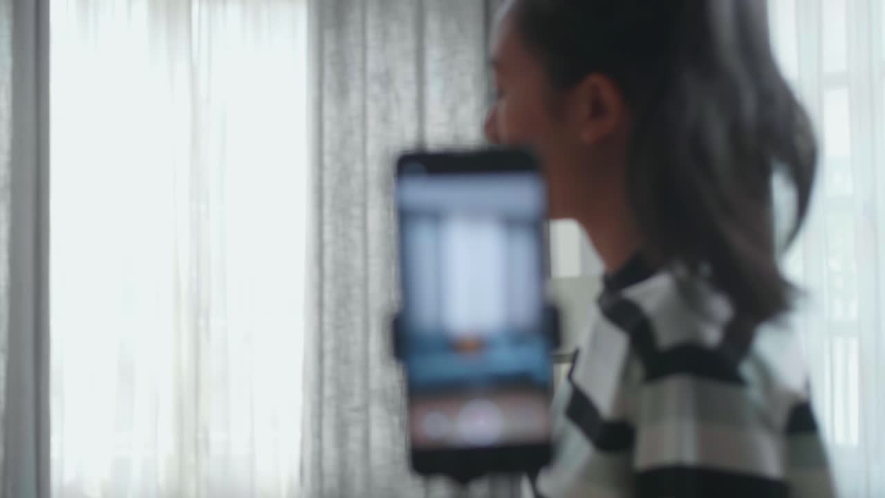 Asian Woman Dancing While Shooting Video Content For Social Networks With A Smartphone Camera