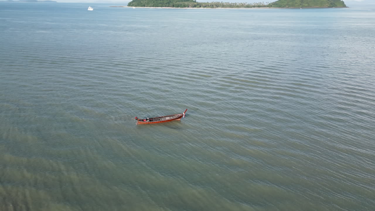 Longtail Boat on the Ocean with Islands in the Background