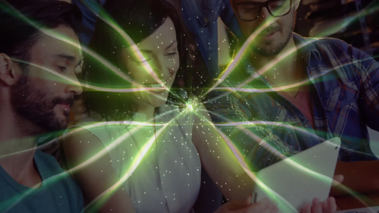 team collaborating around tablet in tech office, with animated energy beams and sparkles