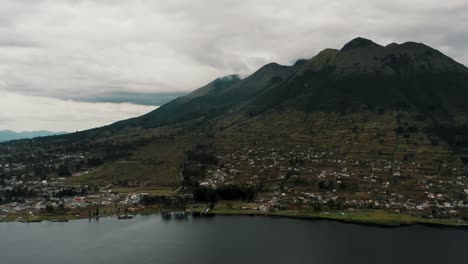 idyllic village of san pablo del lago by the lakeshore with imbabura volcano at background near otavalo in ecuador