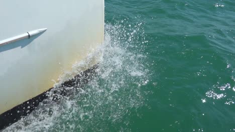 White-catamaran-hull-and-water-splashing-in-slow-motion