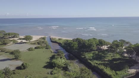 drone flying into the ocean from the oceanside in aerial 4k dominican republic puerto plata