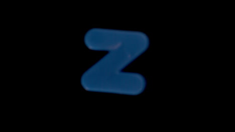 the letter z coming into focus on black background