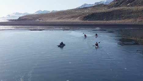 Kayakistas-De-Aventura-Remando-Hacia-La-Playa-Volcánica-En-El-Fiordo-De-Islandia,-Holmanes