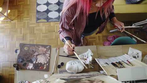 artist happy place working at paint studio pink haired