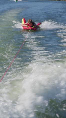 boy tubing on a lake