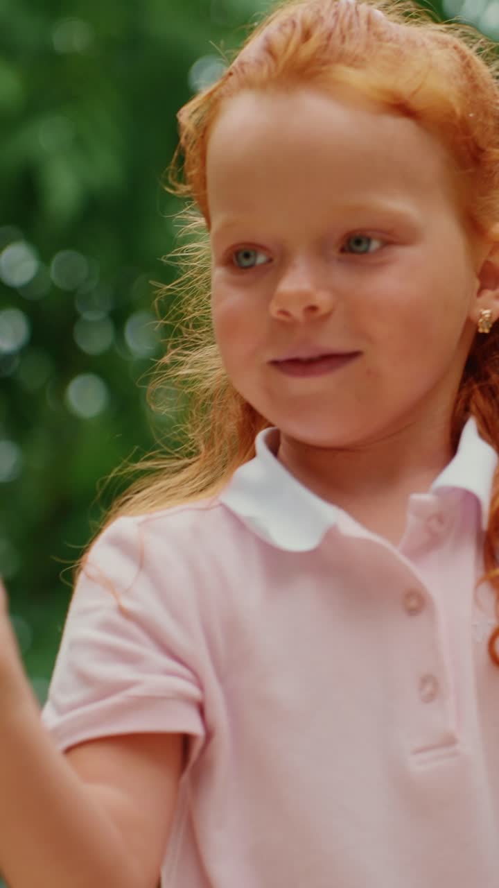 A young girl playing with bubbles outside
