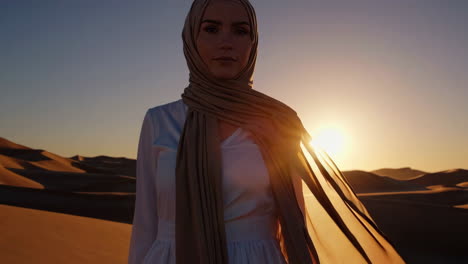 woman in hijab at sunset in the desert