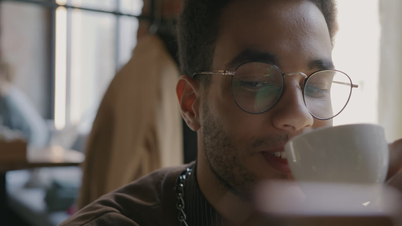 Young Man Enjoying Coffee in a Cafe
