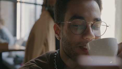 young man enjoying coffee in a cafe
