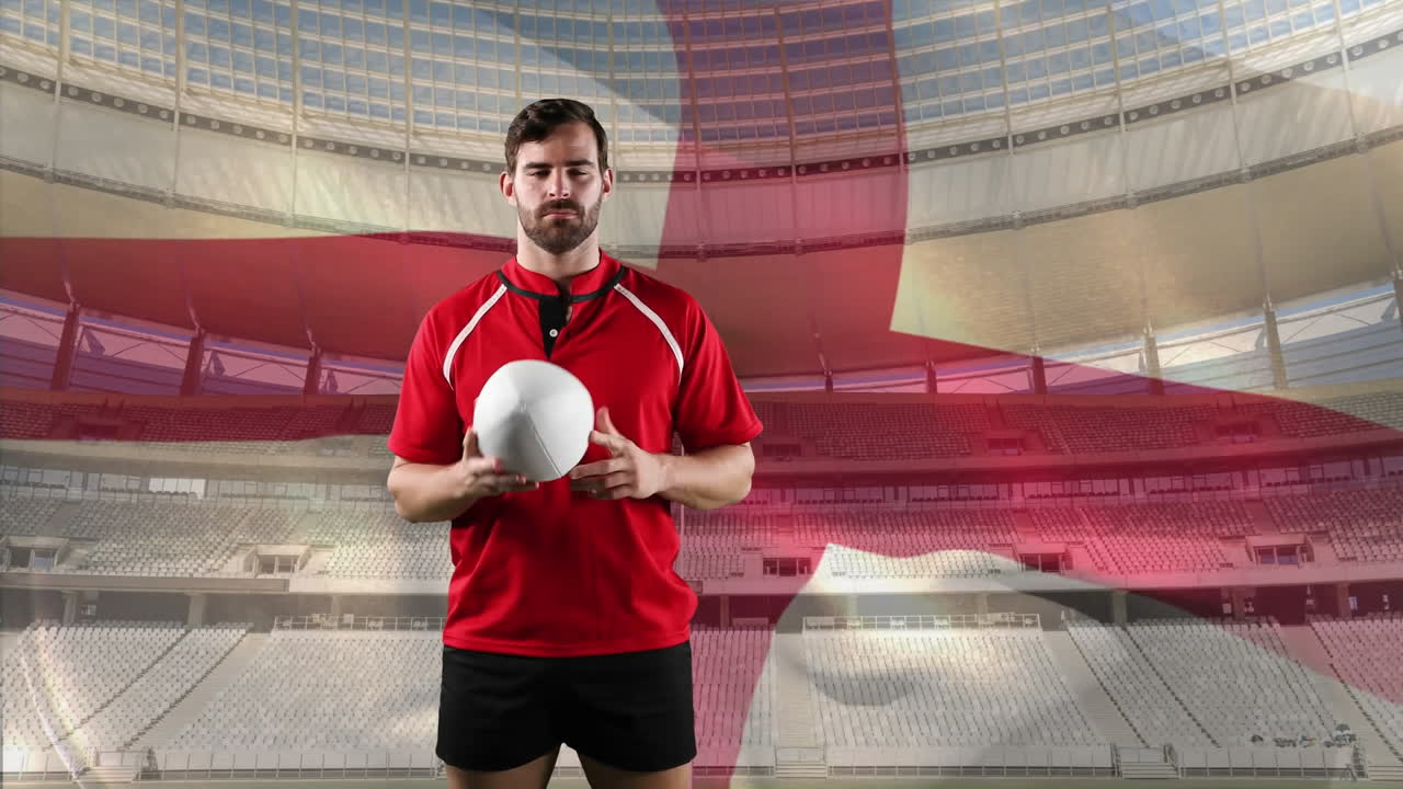 jugador de rugby profesional de pie frente a una bandera y un estadio