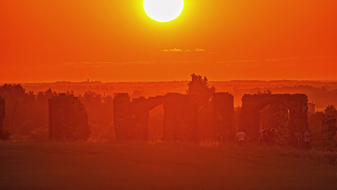 Timelapse Shot Of Golden Yellow Rising Sun On Horizon Over Monument Attraction Bathed In Orange Light. Locked Off