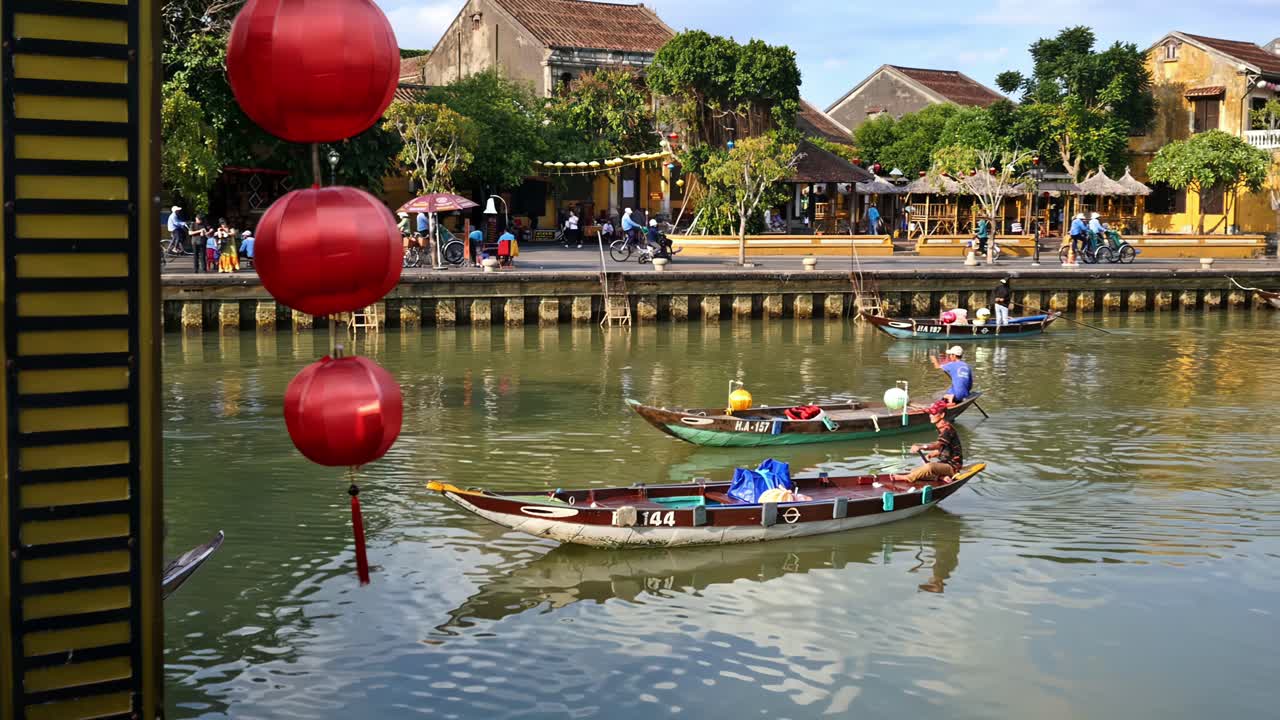 Rowboats serenely travel down Thu Bon River at a section of the Old Quarter in the city of Hoi An, Vietnam.