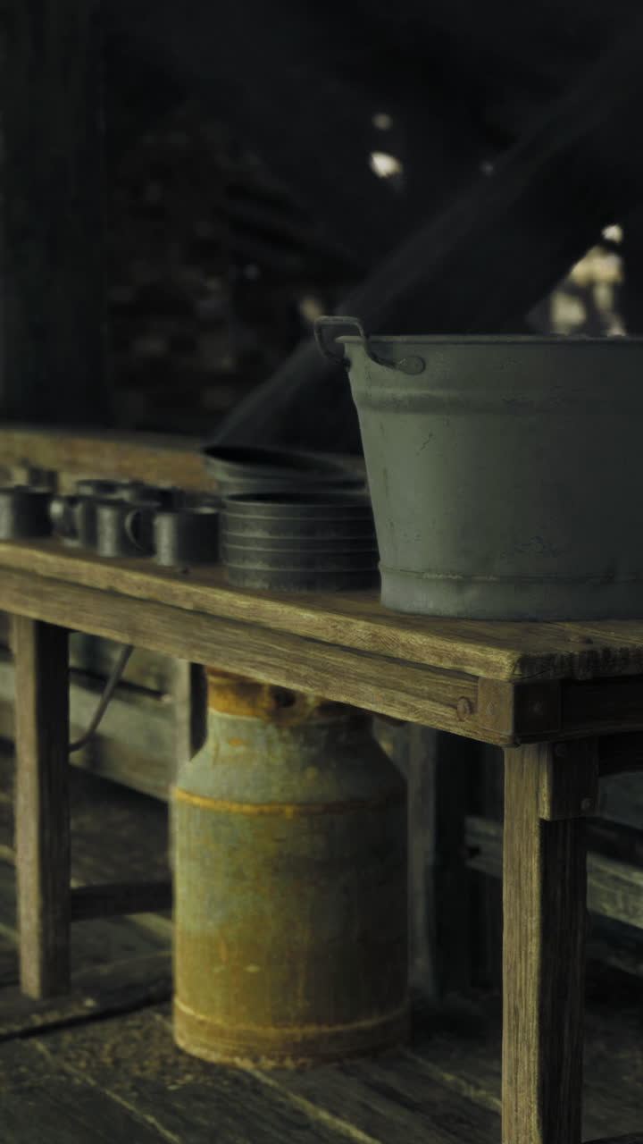 Rustic interior of an old wooden cabin with kitchen supplies at dusk