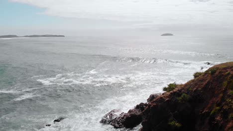 Aerial-drone-view-over-a-rocky-bay-and-waves,-at-the-Emerald-Beach,-Australia