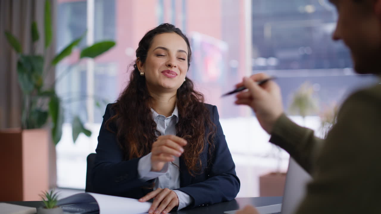 Smiling sales agent talking client giving pen for signing at office portrait