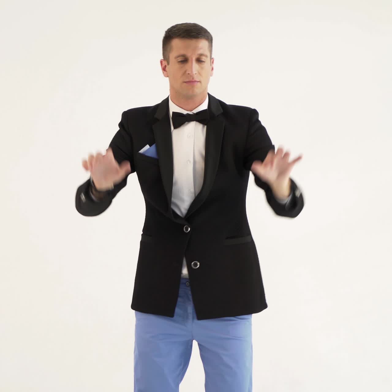 a man in a black jacket is depicting play the piano on a white background in the studio. Parody of the pianist or the instrument