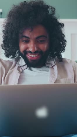focused individual engages with laptop in a cozy indoor setting