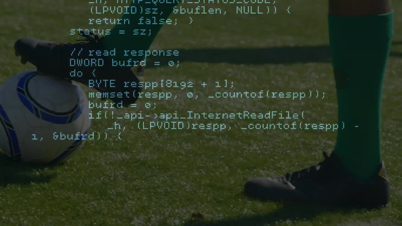 Data processing against low section of male soccer player with soccer ball on sports field