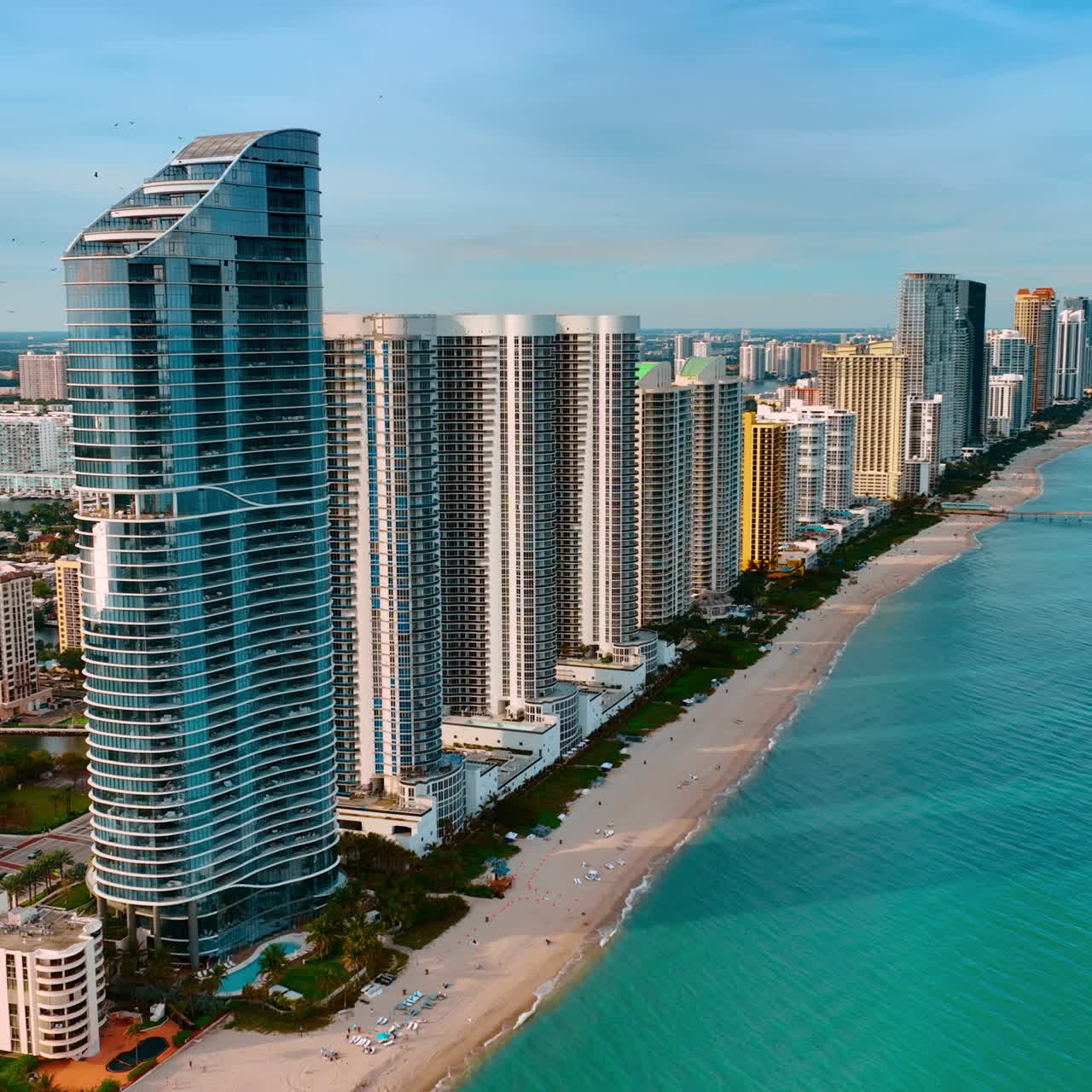 Beautiful high-rise apartment blocks built in row on the shore of the Atlantic Ocean. Miami beach panorama from top.