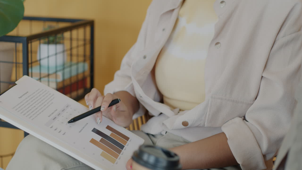 Woman reviewing a document with charts and graphs