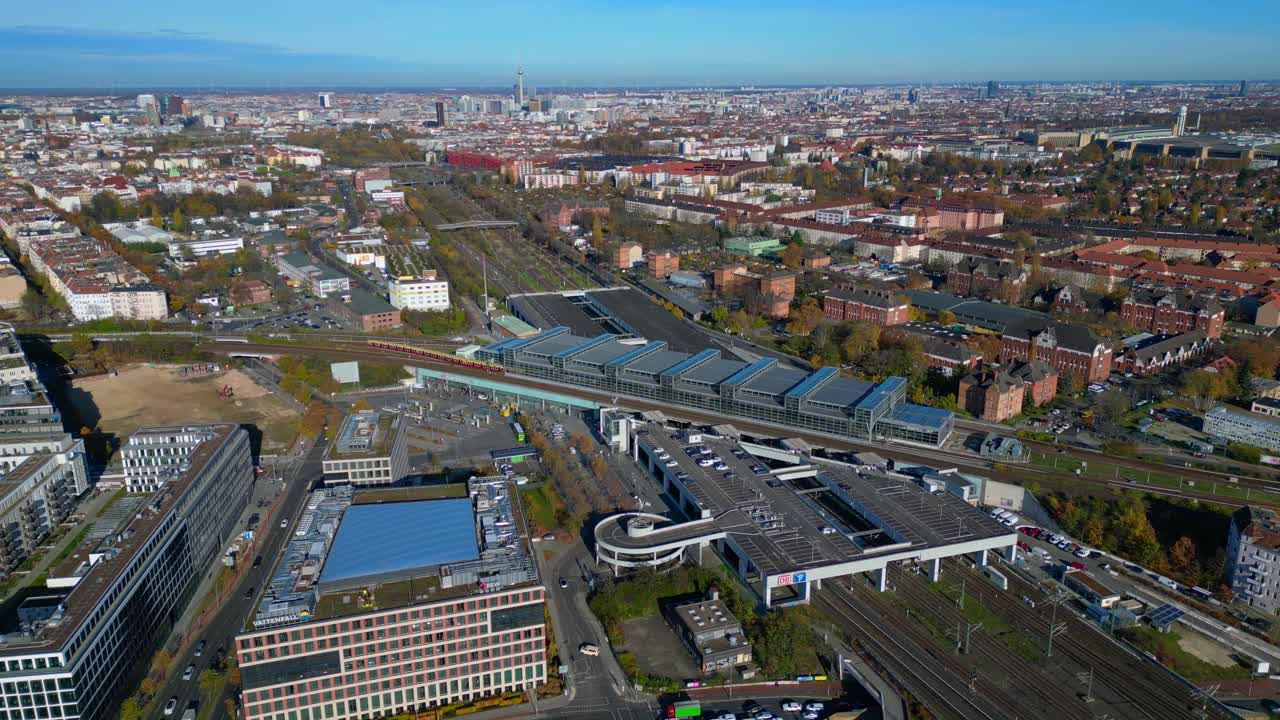 Berlin cityscape with a modern train station South Cross and extensive railway lines under a clear sky. Perfect aerial view flight fly reverse drone