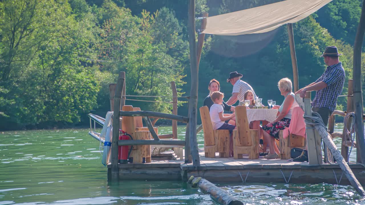 Caucasian raftsmen steer Hlodovc log-raft down the Drava river, Muta, Slovenia, circle pan