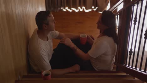 couple at home together on the stairs 4k