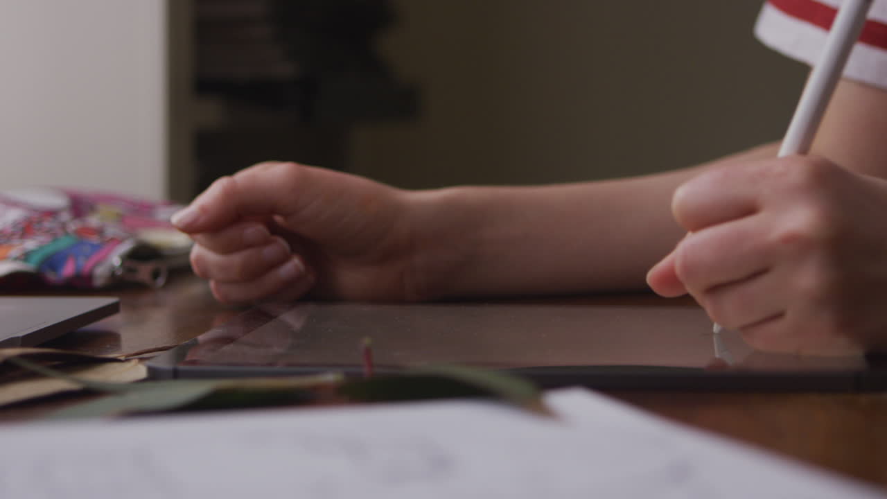 Woman drawing leaves on an ipad using stylus.Digital Art and illustration